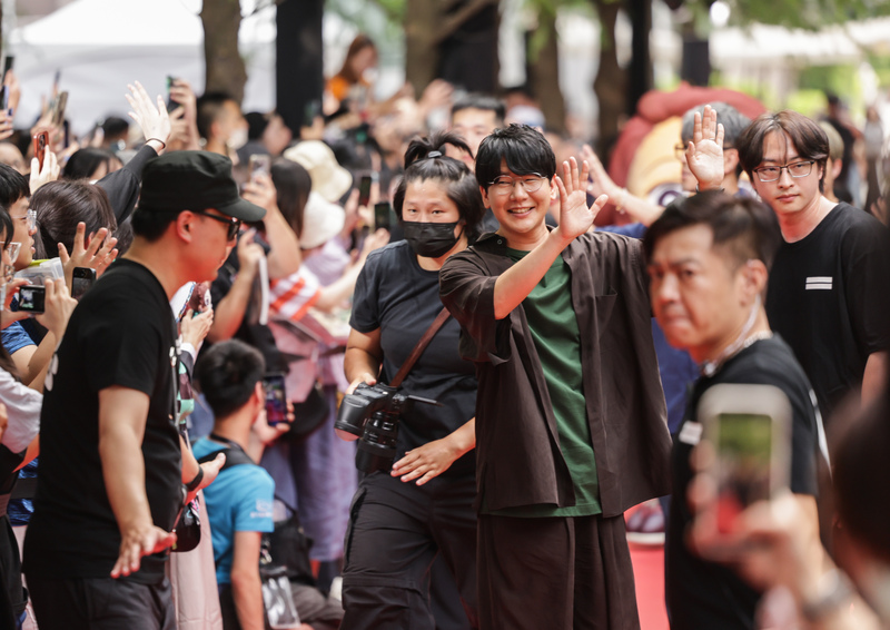 アニメ「鬼滅の刃」主人公・竈門炭治郎の声優、花江夏樹さん（写真中央右・緑の衣装）が、笑顔でファンに手を振って応えた(写真／中央社)