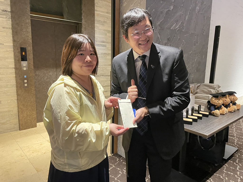 國立陽明交通大學教職員合唱團陳團長致贈禮物給台灣國際美食創新交流協會副會長游巧芸